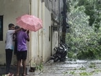 Children shield themselves with an umbrella during a dust storm and rainfall, in New Delhi on Monday, Children shield themselves with an umbrella during a dust storm and rainfall, in New Delhi on Monday, 