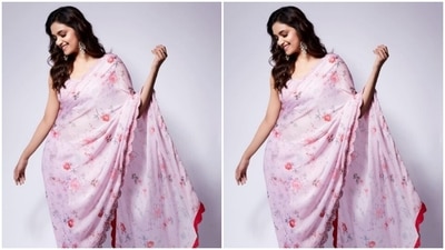 Keerthy decked up in a pastel pink satin saree with minimal floral details and a red border. She teamed it with a sequined pastel pink blouse with a tie-up detail at the back. (Instagram/@keerthysureshofficial)