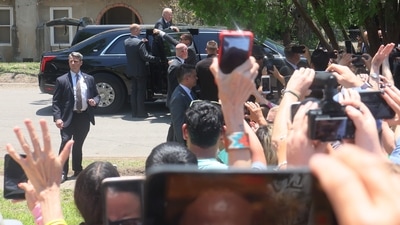 President Joe Biden hangs out of his car as he acknowledges a crowd after attending mass at Sacred Heart Catholic Church on May 29, 2022 in Uvalde, Texas. (AFP) President Joe Biden hangs out of his car as he acknowledges a crowd after attending mass at Sacred Heart Catholic Church on May 29, 2022 in Uvalde, Texas. (AFP)