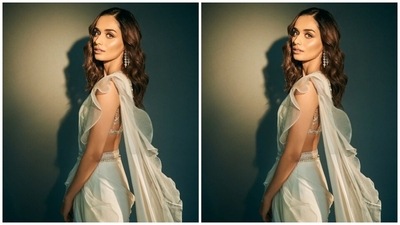 Manushi's saree set is from the shelves of designer Ridhi Mehra's clothing line. The draped georgette six yards comes adorned with feather-light ruffles all over. The 25-year-old wore it in the traditional draping style, flaunting her toned midriff and pallu falling from the shoulder. Silver and white belt embellished with shimmering pearls and gota patti cinched the saree and the pallu at the waist. (Instagram) Manushi's saree set is from the shelves of designer Ridhi Mehra's clothing line. The draped georgette six yards comes adorned with feather-light ruffles all over. The 25-year-old wore it in the traditional draping style, flaunting her toned midriff and pallu falling from the shoulder. Silver and white belt embellished with shimmering pearls and gota patti cinched the saree and the pallu at the waist. (Instagram)