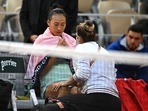 China's Qinwen Zheng receives medical attention during the match