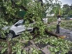 A view of a tree uprooted and fallen on a car at Harish Chander Mathur Lane following heavy thunderstorms and rain in New Delhi.(Photo by Raj K Raj/ Hindustan Times)