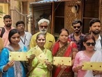Women showing sealed envelop carrying footage and photographs of survey carried out inside the Gyanvapi mosque. (HT Photo) Women showing sealed envelop carrying footage and photographs of survey carried out inside the Gyanvapi mosque. (HT Photo)
