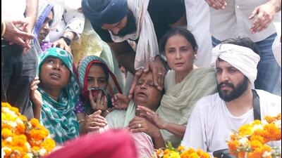 People trying to console mother of Sidhu Moose Wala, Charan Kaur, during the singer-politician’s cremation at Moosa village in Mansa on Tuesday. (Sanjeev Kumar/HT) People trying to console mother of Sidhu Moose Wala, Charan Kaur, during the singer-politician’s cremation at Moosa village in Mansa on Tuesday. (Sanjeev Kumar/HT)