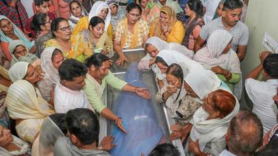 Relatives and family members of teacher Rajni Bala mourn near her mortal remains, at their residence in Samba on Tuesday. (PTI) Relatives and family members of teacher Rajni Bala mourn near her mortal remains, at their residence in Samba on Tuesday. (PTI)