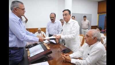 Haryana Congress candidate Ajay Makan filling nomination for Rajya Sabha polls in the presence of former Haryana CM Bhupinder Singh Hooda in Chandigarh on Tuesday. (Keshav Singh/HT) Haryana Congress candidate Ajay Makan filling nomination for Rajya Sabha polls in the presence of former Haryana CM Bhupinder Singh Hooda in Chandigarh on Tuesday. (Keshav Singh/HT)