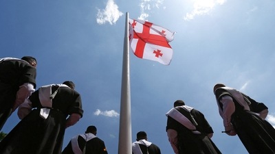 Men wearing traditional clothes stand next to the Georgian flag during the Independence Day celebrations in Tbilisi, Georgia May 26, 2022. REUTERS/Irakli Gedenidze (REUTERS)