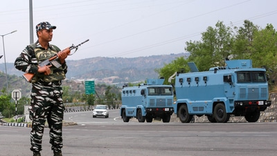 A CRPF personnel stands guard at the Jammu-Srinagar National Highway. (PTI) A CRPF personnel stands guard at the Jammu-Srinagar National Highway. (PTI)