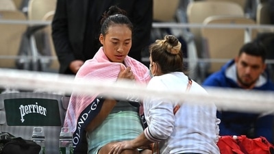 China's Qinwen Zheng receives medical attention during the match (REUTERS)