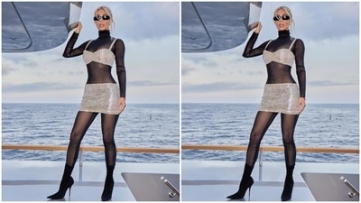 The sheer full bodysuit covered Kim from head to toe, and it comes in a black shade. It also features full sleeves, a turtle neckline and a body-hugging silhouette accentuating Kim's infamous curves. The Skims founder layered the bodysuit with a silver crystal-embellished bralette and matching mini skirt set. (Instagram) The sheer full bodysuit covered Kim from head to toe, and it comes in a black shade. It also features full sleeves, a turtle neckline and a body-hugging silhouette accentuating Kim's infamous curves. The Skims founder layered the bodysuit with a silver crystal-embellished bralette and matching mini skirt set. (Instagram)