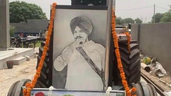 A portrait of late singer Sidhu Moose Wala on his favourite tractor 5911.