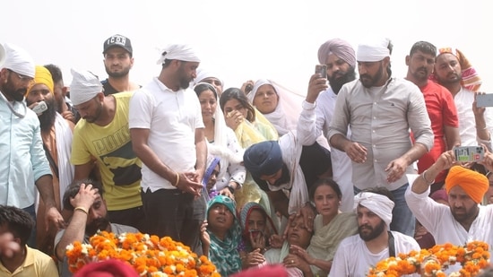 Sidhu Moose Wala's mother being consoled at the funeral ceremony. (Sanjeev Kumar/HT Photo).