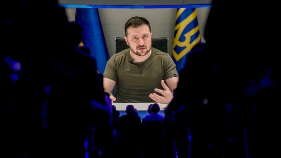 FILE - Ukrainian President Volodymyr Zelensky is seen on a screen addressing the audience from Kyiv during the World Economic Forum in Davos, Switzerland.(AP)