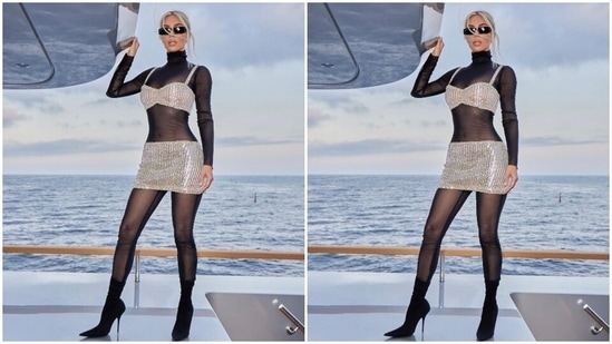 The sheer full bodysuit covered Kim from head to toe, and it comes in a black shade. It also features full sleeves, a turtle neckline and a body-hugging silhouette accentuating Kim's infamous curves. The Skims founder layered the bodysuit with a silver crystal-embellished bralette and matching mini skirt set.(Instagram)