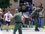 Children run to safety after escaping from a window during a mass shooting at Robb Elementary School where a gunman killed nineteen children and two adults in Uvalde, Texas, U.S. May 24.