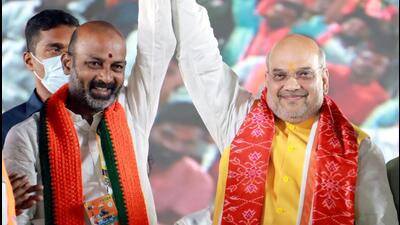 Union home minister Amit Shah with Telangana BJP president Bandi Sanjay during a public meeting at Thukkuguda near Hyderabad. (ANI) Union home minister Amit Shah with Telangana BJP president Bandi Sanjay during a public meeting at Thukkuguda near Hyderabad. (ANI)