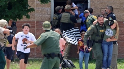 Children run to safety after escaping from a window during a mass shooting at Robb Elementary School where a gunman killed nineteen children and two adults in Uvalde, Texas, U.S. May 24. (via REUTERS)