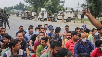 Kashmiri pandits employed under the PM package shout slogans and block Jammu-Srinagar national highway at Qazigund in Anantnag to protest against the killing of the school teacher Rajni Bala. (PTI) Kashmiri pandits employed under the PM package shout slogans and block Jammu-Srinagar national highway at Qazigund in Anantnag to protest against the killing of the school teacher Rajni Bala. (PTI)
