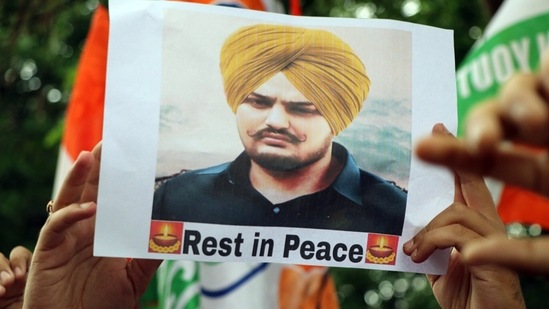 A Jammu and Kashmir Youth Congress supporter holding a placard stage a protest against the Punjab government over the recent killing of Punjabi singer and Congress leader Sidhu Moose Wala in the Mansa district.&nbsp;(ANI)