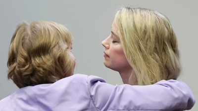 Actor Amber Heard hugs her attorney Elaine Bredehoft after the verdict was read at the Fairfax County Circuit Courthouse. (AP)