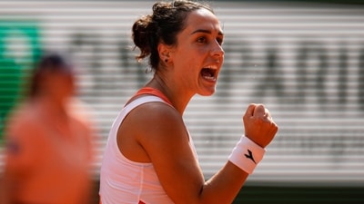 Martina Trevisan clenches her fist after scoring a point against Coco Gauff during their semifinal match at the French Open (AP)