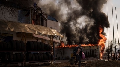A man recovers items from a shop that caught fire from a Russian attack in Kharkiv, Ukraine, Friday, March 25, 2022. (AP Photo/Felipe Dana) A man recovers items from a shop that caught fire from a Russian attack in Kharkiv, Ukraine, Friday, March 25, 2022. (AP Photo/Felipe Dana)
