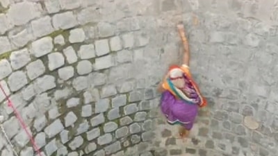 In the video, woman can be seen climbing up the sheer wall of the well. (ANI) In the video, woman can be seen climbing up the sheer wall of the well. (ANI)
