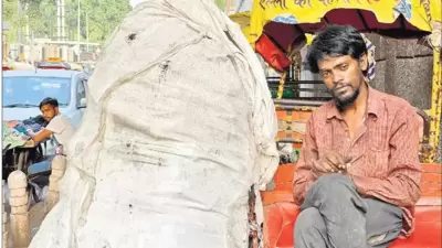 Fajru Rahman is sitting on a rickshaw (not his) parked by the roadside, close to Old Delhi’s Kasturba Gandhi Hospital for Women and Children. (Mayank Austen Soofi)
