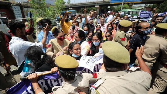 Police personnel stop members of Jammu Based Reserved Category Employees Association Kashmir during a protest demanding justice for Rajni Bala, who was shot dead by terrorists on May 31, in Jammu on Thursday. (ANI)