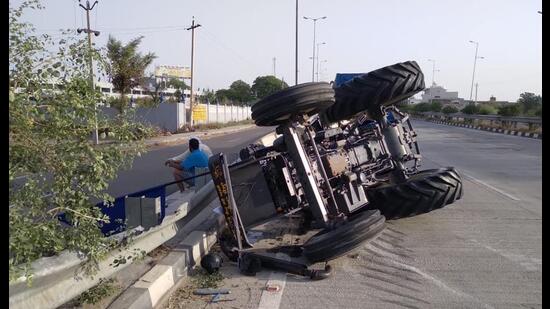 The tractor-trailer that overturned after being hit by a truck on the Amritsar-Bathinda national highway near Tarn Taran on Thursday. (HT Photo)
