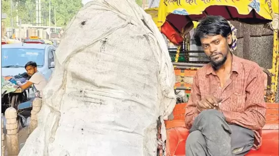 Fajru Rahman is sitting on a rickshaw (not his) parked by the roadside, close to Old Delhi’s Kasturba Gandhi Hospital for Women and Children. (Mayank Austen Soofi)