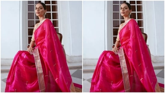 For the occasion, Manushi draped herself in a fuchsia pink saree from the heritage clothing label, Madhurya. The star paired the six yards with a cream-coloured half-sleeve silk blouse featuring a wide neckline. Manushi's ensemble is a perfect pick for low-key events where you want to embrace minimalism and still look incredible.(Instagram)