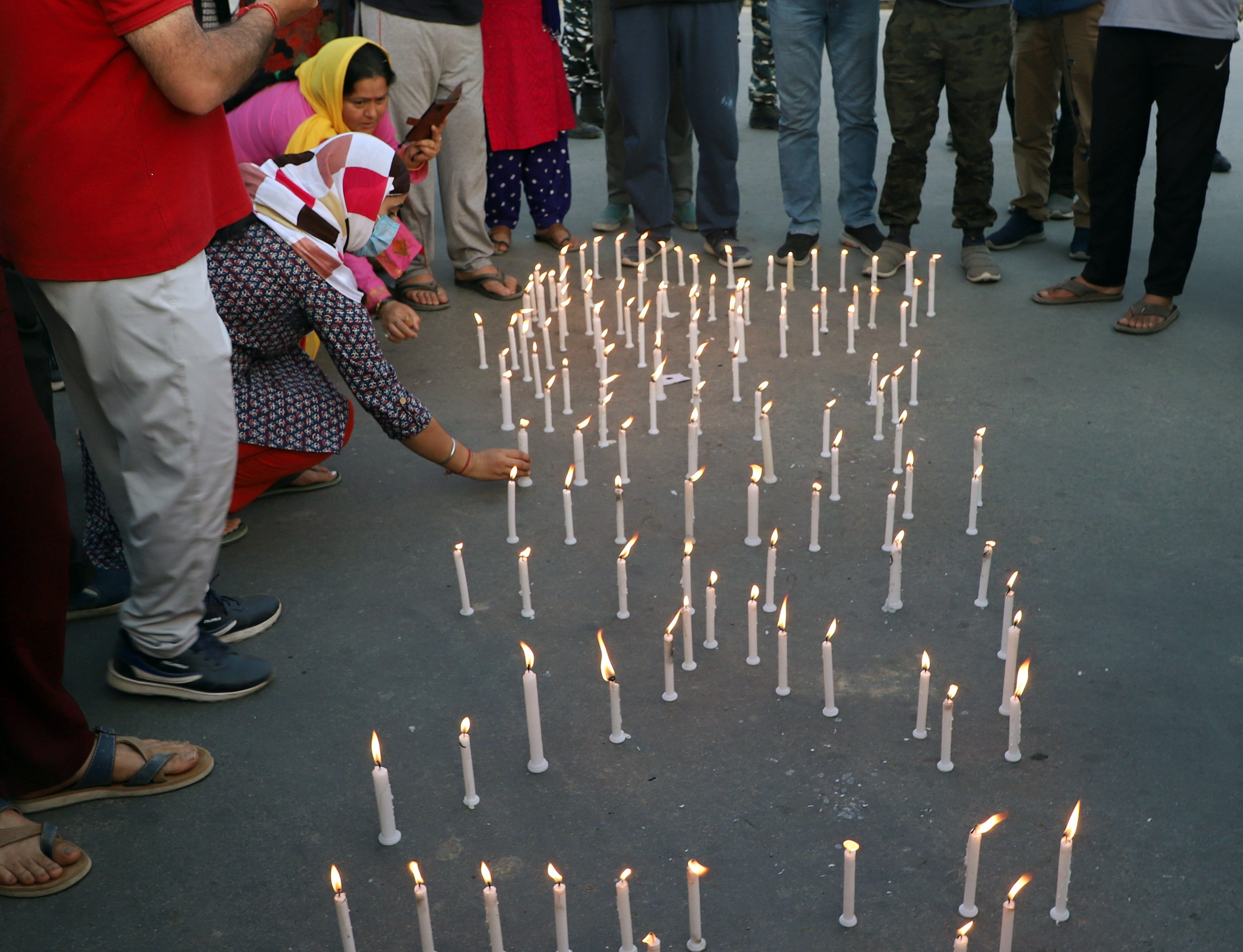 Kashmiri pandits light candles during a protest against the killing of a Kashmiri Pandit Rahul Bhat on May 19. (Imran Nissar/ANI) Kashmiri pandits light candles during a protest against the killing of a Kashmiri Pandit Rahul Bhat on May 19. (Imran Nissar/ANI)