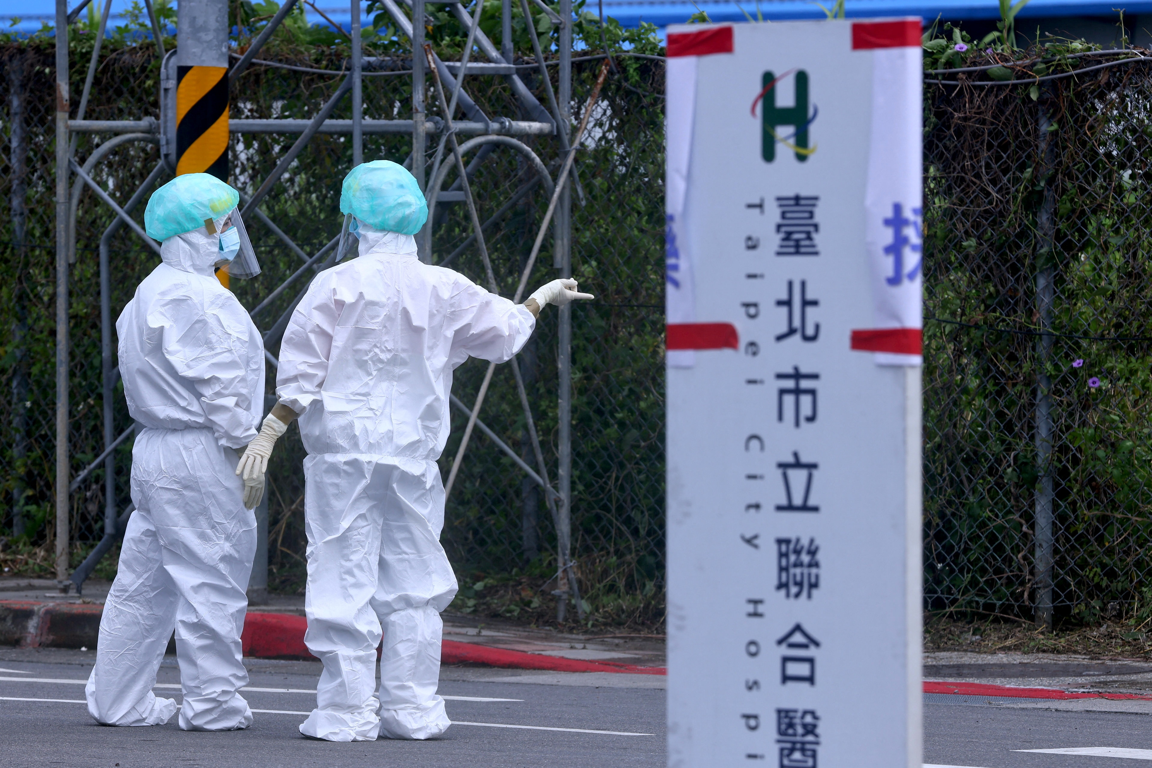 File photo - Two medical workers in full PPE talk to each other. (REUTERS)