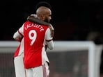 Alexandre Lacazette, front is hugged by Arsenal's Thomas Partey (AP)