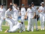 England's Jonny Bairstow celebrates with Ben Stokes and teammates after taking a catch to dismiss New Zealand's Tom Latham off the bowling of James Anderson Action