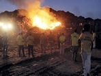 New Delhi: People look on as smoke billows from a fire at Bhalswa landfill, in New Delhi, Friday, June 3, 2022. (PTI Photo)