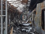 A local resident stands next to debris of an open market destroyed by a military strike, as Russia's attack on Ukraine continues, in Sievierodonetsk.