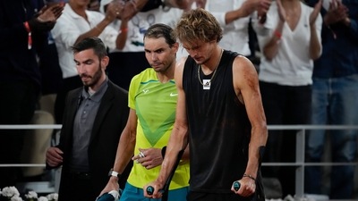 Rafael Nadal walks alongside Germany's Alexander Zverev who retired with an ankle injury in the semifinal match (AP) Rafael Nadal walks alongside Germany's Alexander Zverev who retired with an ankle injury in the semifinal match (AP)