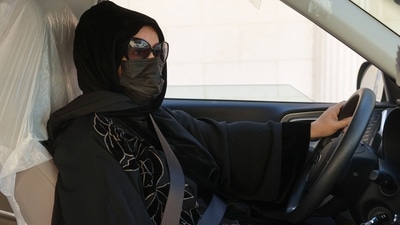 Saudi taxi driver Fahda Fahd sits in her car in the capital Riyadh. (AFP) Saudi taxi driver Fahda Fahd sits in her car in the capital Riyadh. (AFP)