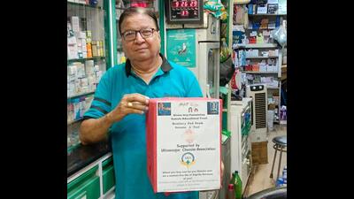 Suresh Ahuja, owner of the 64-year-old chemist store in Ulhasnagar, Mahadev Chemist, with a sanitary pad donation box at his shop. The donated pads will be distributed to the under-privileged women. (HT PHOTO)