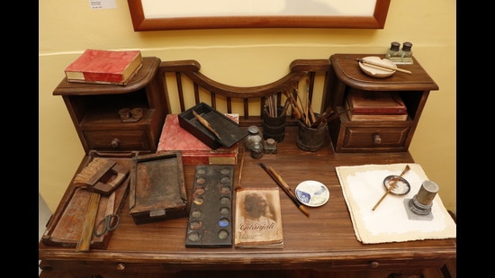 A replica of Rabindranath Tagore’s writing table with a copy of Gitanjali, a collection of his poems, and paint brushes drawing attention to his overall personality. (Photo: Dhruv Sethi/HT)