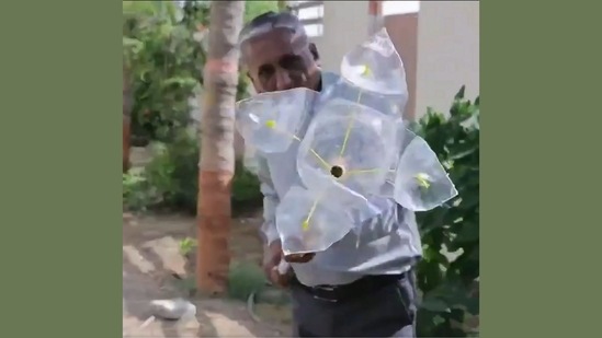 The image is taken from the video shared by Anand Mahindra that demonstrates how a DIY fruit plucking tool can be made from scrap. (Twitter/@anandmahindra) The image is taken from the video shared by Anand Mahindra that demonstrates how a DIY fruit plucking tool can be made from scrap. (Twitter/@anandmahindra)