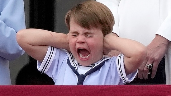 Britain's Prince Louis is seen covering his ears with his hands on the balcony of Buckingham Palace during the Royal Air Force flyby.(AP)
