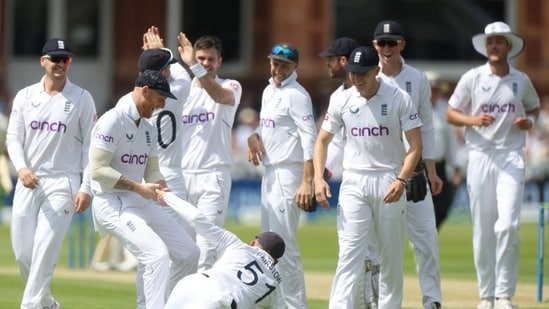 England's Jonny Bairstow celebrates with Ben Stokes and teammates after taking a catch to dismiss New Zealand's Tom Latham off the bowling of James Anderson Action(Action Images via Reuters)