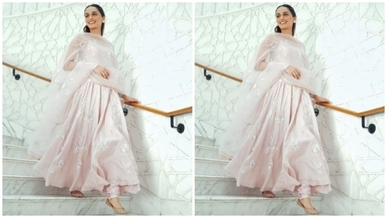 Manushi paired the kurta with matching pale pink churidar pants and a sheer organza dupatta draped elegantly on her shoulders. The dupatta comes with a similar lily embroidered pattern adorned with gold embellishments and a gold patti border.(Instagram)