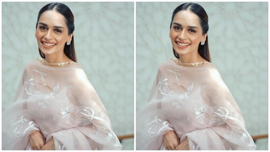 Manushi wore a breezy anarkali kurta in a pale pink shade for promoting Samrat Prithviraj. It comes replete with embroidered lily patterns done in an ivory shade and embellished with gold diamantes. The kurta also features thin straps, a wide U neckline, a fit and flared silhouette and pleated details on the skirt.(Instagram)