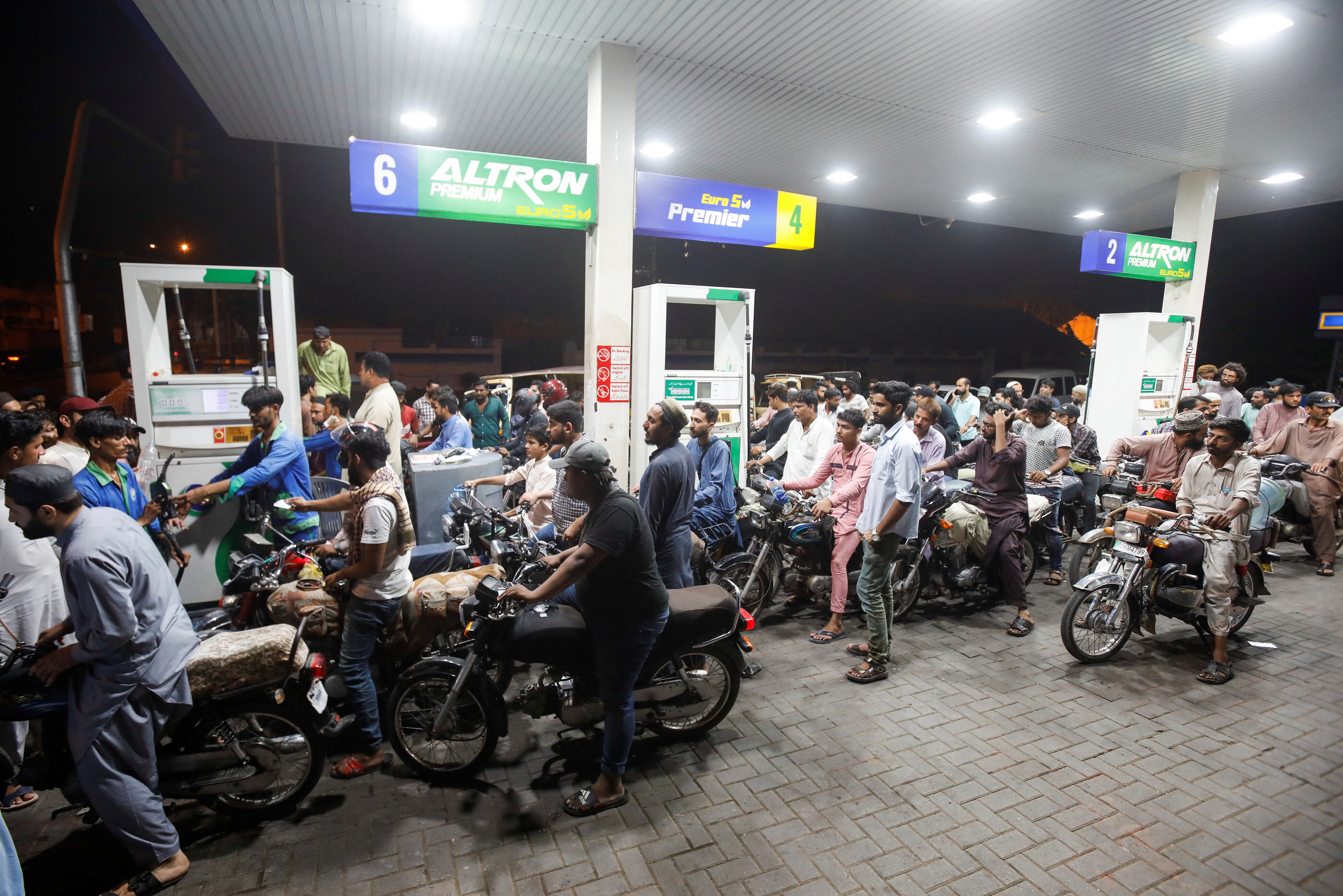 People wait their turn to get fuel at a petrol station, in Karachi, on June 2, 2022.&nbsp; (Reuters photo)