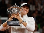 Poland's Iga Swiatek celebrtes with trophy after winning the women's singles final match against Cori Gauff of the U.S