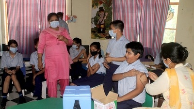 A healthcare worker inoculates a student with a dose of the Covid-19 vaccine during a vaccination drive, at a school, in Patiala. (HT Photo)